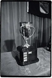 Prints of Photo shows the Calder Hockey Trophy Frozen Moments: A Journey Through Hockey History: Hockey Trophy Standing on Table