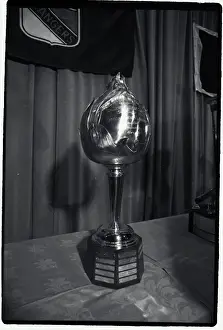 Prints of Photo shows the Hart Hockey Trophy Frozen Moments: A Journey Through Hockey History: Hockey Trophy Standing on Table