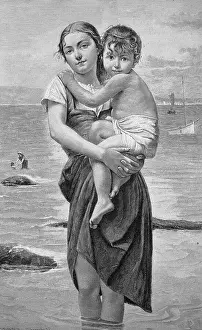 Concerned Prints: Holiday by the sea, young mother standing with her legs in the water holding her son who is afraid of the sea