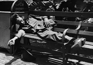 Homeless Man Missing Leg Sleeping on Bench