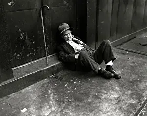 Homelessness Prints: Homeless Man Sleeping on a Sidewalk