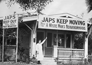 Homeowner Pointing to Anti-Japanese Sign
