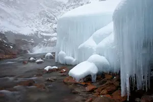 Icicle Prints: Honshu island, Nagano, Japan. Icicles and blocks of frozen snow by a stream