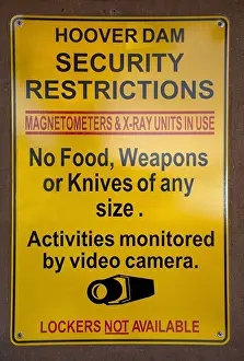 Prints of HOOVER DAM, NV - MARCH 30: A sign warns visitors at Hoover Dam in Nevada not to bring weapons to the dam, on March 30, 2016 A Timeless Collection of Hoover Dam Photography: Hoover Dam