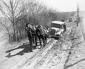 Unpaved Road Prints: Horses Pulling Truck out of Muddy Road