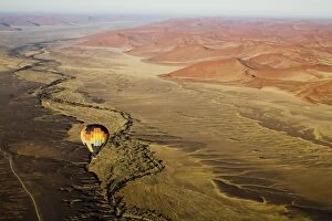 Images Dated 26th September 2008: Hot air balloon over desert landscape