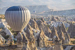 Images Dated 22nd September 2015: Hot air balloon flying over rock landscape at Cappadocia Turkey