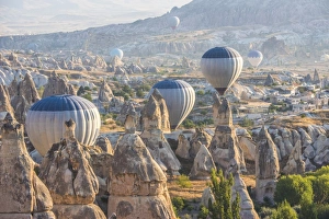 Images Dated 22nd September 2015: Hot air balloon flying over rock landscape at Cappadocia Turkey