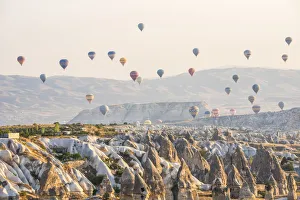 Images Dated 22nd September 2015: Hot air balloon flying over rock landscape at Cappadocia Turkey