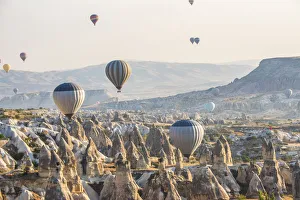 Images Dated 22nd September 2015: Hot air balloon flying over rock landscape at Cappadocia Turkey