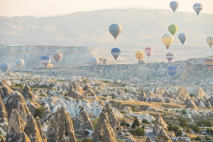 Images Dated 22nd September 2015: Hot air balloon flying over rock landscape at Cappadocia Turkey