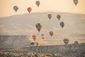 Images Dated 22nd September 2015: Hot air balloon flying over rock landscape at Cappadocia Turkey
