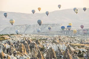 Images Dated 22nd September 2015: Hot air balloon flying over rock landscape at Cappadocia Turkey