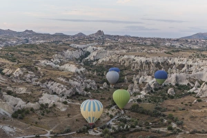 Images Dated 23rd September 2015: Hot air balloon flying over rock landscape at Cappadocia Turkey