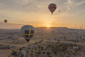 Images Dated 23rd September 2015: Hot air balloon flying over rock landscape at Cappadocia Turkey