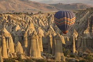 Aerial Collection: Hot air balloon flying over rock landscape at Cappadocia Turkey