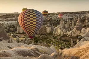 Images Dated 29th August 2016: Hot air balloon flying over rock landscape at Cappadocia Turkey