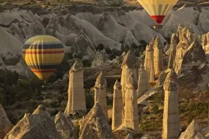 Images Dated 29th August 2016: Hot air balloon flying over rock landscape at Cappadocia Turkey