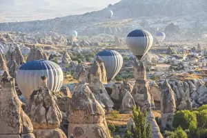 Hot air balloon flying over rock landscape at Cappadocia Turkey