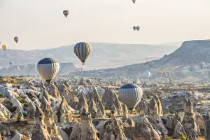 Hot air balloon flying over rock landscape at Cappadocia Turkey