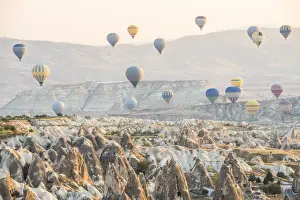 Hot air balloon flying over rock landscape at Cappadocia Turkey
