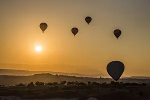 Hot air balloon flying over rock landscape at Cappadocia Turkey