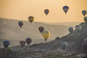 Hot air balloon flying over rock landscape at Cappadocia Turkey