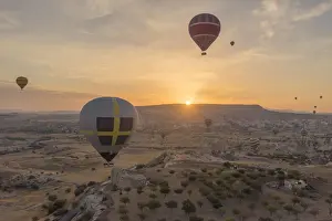 Hot air balloon flying over rock landscape at Cappadocia Turkey