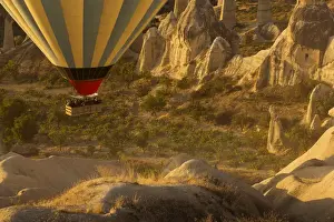 Hot air balloon flying over rock landscape at Cappadocia Turkey