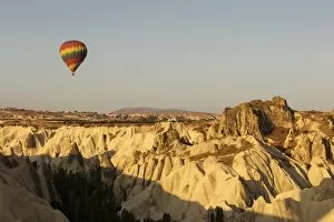 Images Dated 28th August 2016: Hot air balloon flying over rock landscape at Cappadocia Turkey