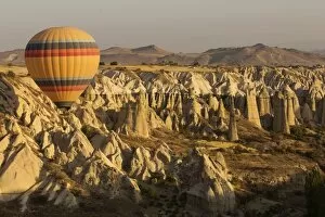 Images Dated 28th August 2016: Hot air balloon flying over rock landscape at Cappadocia Turkey