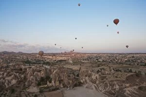 Images Dated 21st May 2015: Hot air balloons flying over dramatic landscape