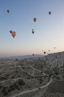 Images Dated 21st May 2015: Hot air balloons flying over rocky landscape