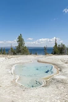 Hot spring, clear water, Perforated Pool, West Thumb, Yellowstone Lake in the background, Yellowstone National Park