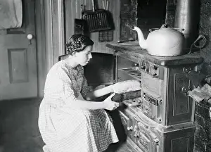 Housekeeper Putting Food in Oven