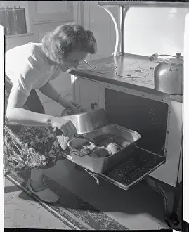 Housewife Checking on Chicken in Oven