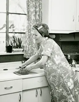 40 49 Years Prints: Housewife doing dishes at kitchen sink, (B&W)
