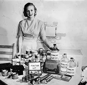 Housewife Posing With Bomb Shelter Supplies