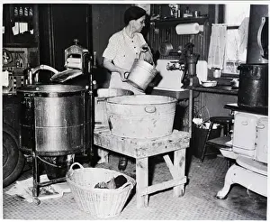 Basin Prints: Housewife Is Shown Pumping Water In Kitc
