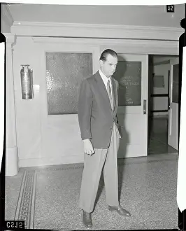 Howard Hughes Standing in Hallway