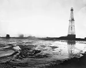 Derrick Prints: Huge Lake Of Oil Around Oil Well