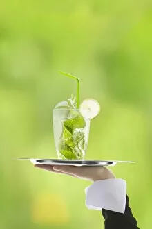 Images Dated 16th February 2013: Hugo cocktail with lime and mint being served on a tray