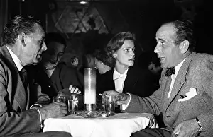 Prints of May 1951: American actor Humphrey Bogart (1899-1957) dining out with his fourth wife Lauren Bacall, prior to his trip to Europe and Africa to make The African Queen' The Essence of Cool: Humphrey Bogart