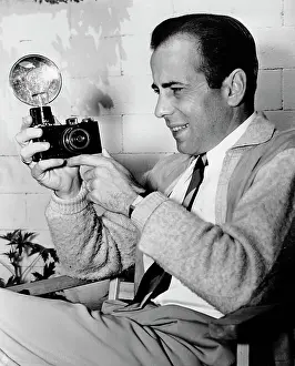 Prints of American actor Humphrey Bogart (1899 - 1957) holding a camera on the set of the film They Drive by Night, circa 1940. (Photo by Archive Photos/Getty Images) The Essence of Cool: Humphrey Bogart