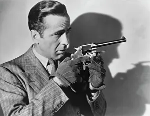 Prints of American actor Humphrey Bogart (1899 Ð 1957) in the 1941 film All Through The Night'. (Photo by Archive Photos/Getty Images) The Essence of Cool: Humphrey Bogart With A Gun