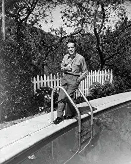 Prints of (Original Caption). Humphrey Bogart, star of Warner Bros. Chain Lightening, on the grounds of his Beverly Hills home The Essence of Cool: Humphrey Bogart Posing at Poolside