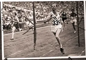 Wembley Prints: Hurdler Roy Cochran Crossing Finish Line in Olympics
