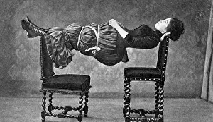 Balancing Prints: Hypnotised Woman Between Two Chairs