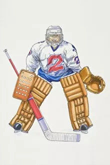 Ice hockey goalkeeper standing poised with legs apart, holding stick, wearing large knee pads, catch gloves and helmet