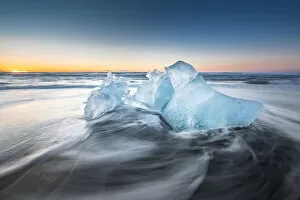 Ice on ice beach with water wave in Jokulsarlon, Iceland